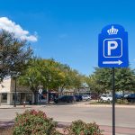 view down Main Street filled with parked vehicles behind a blue Bryan parking sign