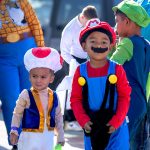 group of children dressed as characters for halloween at a trick or treating event