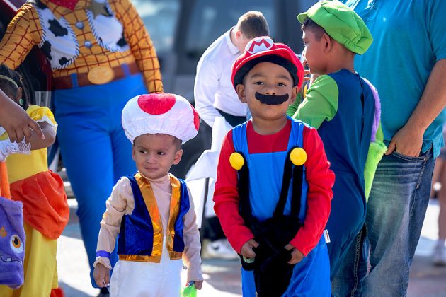 group of children dressed as characters for halloween at a trick or treating event