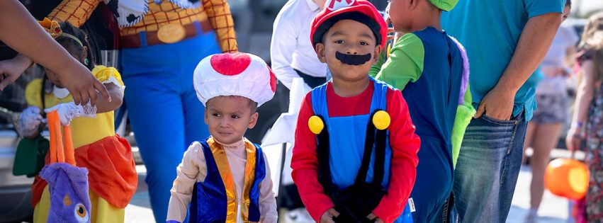 group of children dressed as characters for halloween at a trick or treating event
