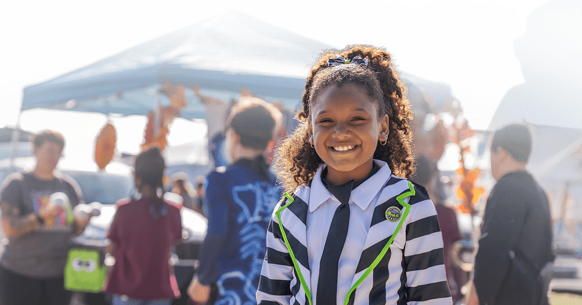 children dressed as characters for halloween having fun at a community event